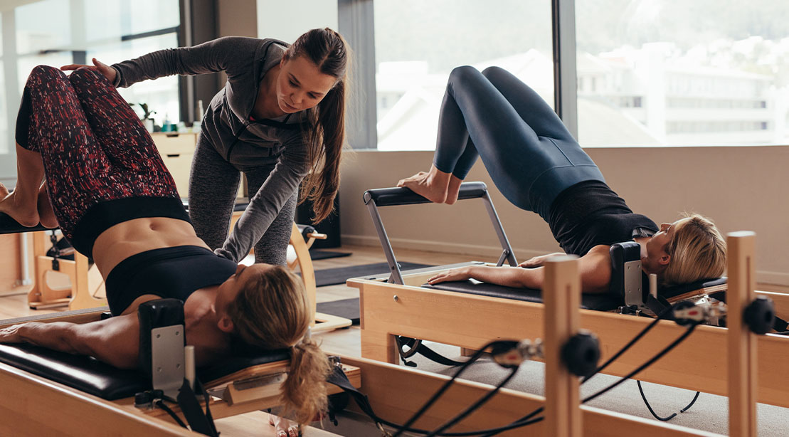 Pilates instructor teaching a pilates class